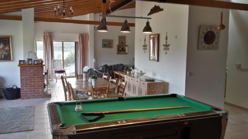 a room with a pool table and a living room at Villa in Moniatis in Moniatis