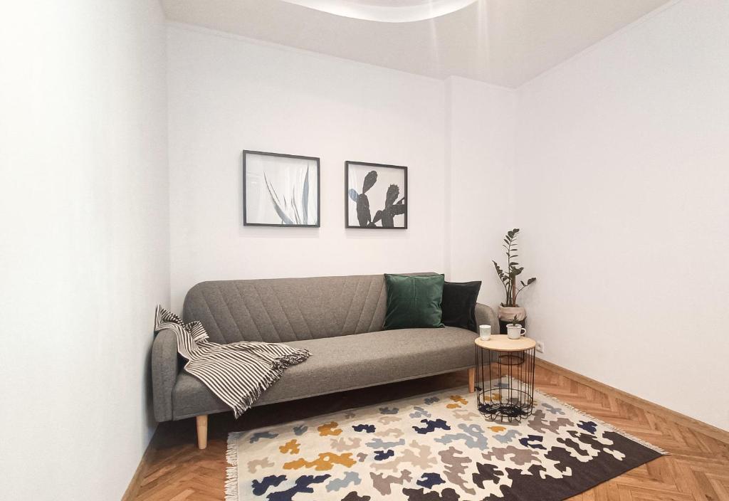 a living room with a couch and a rug at Apartment Balabanov in Varna City