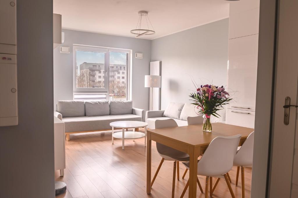 a living room with a table and a couch at Marywilska apartment in Warsaw