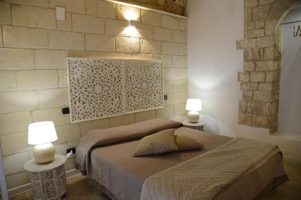 um quarto com uma cama e 2 candeeiros nas mesas em La Stanza em Bari