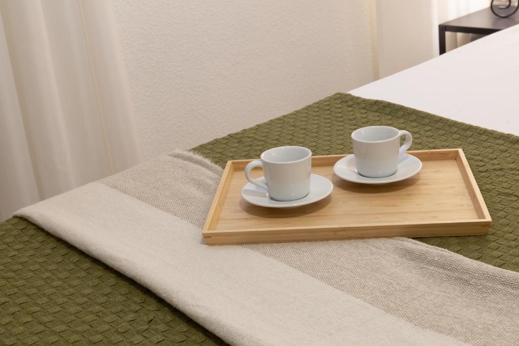 A bed or beds in a room at Suite Málaga Center