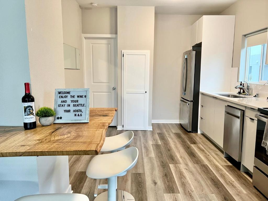 a kitchen with a wooden table and white chairs at Perfect Workation Spot, Fast Wi-Fi, Fully Stocked in Seattle