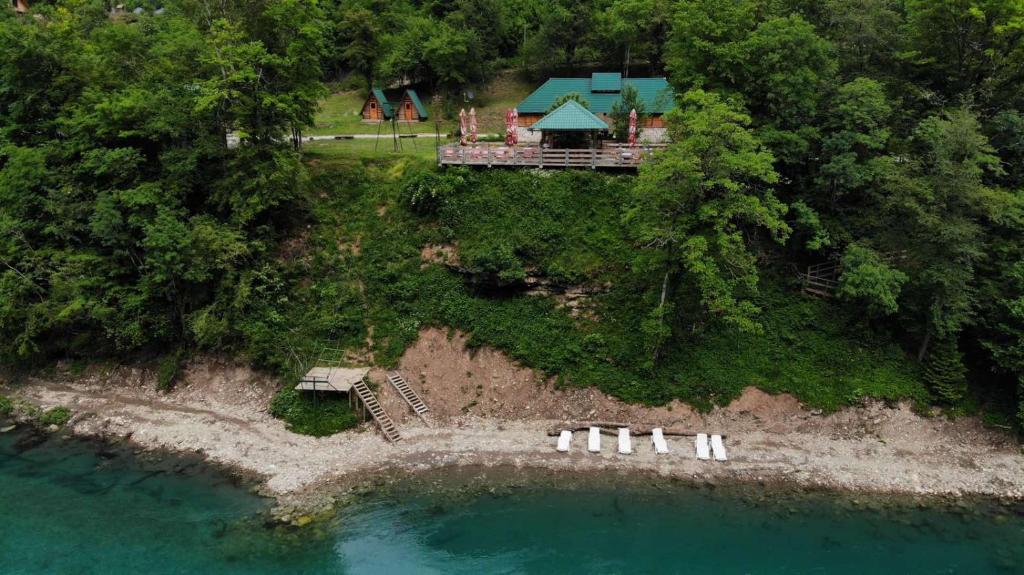 an aerial view of a house on an island in the water at Rafting Tara Camp Highlander in Bastasi