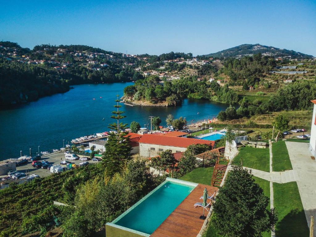 an aerial view of a river and a resort at Costeira Douro in Castelo de Paiva