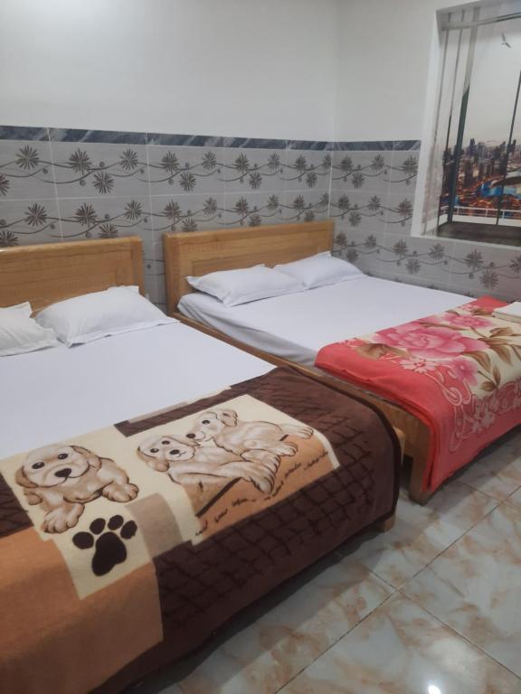Postel nebo postele na pokoji v ubytování Nhà Nghỉ An Toàn