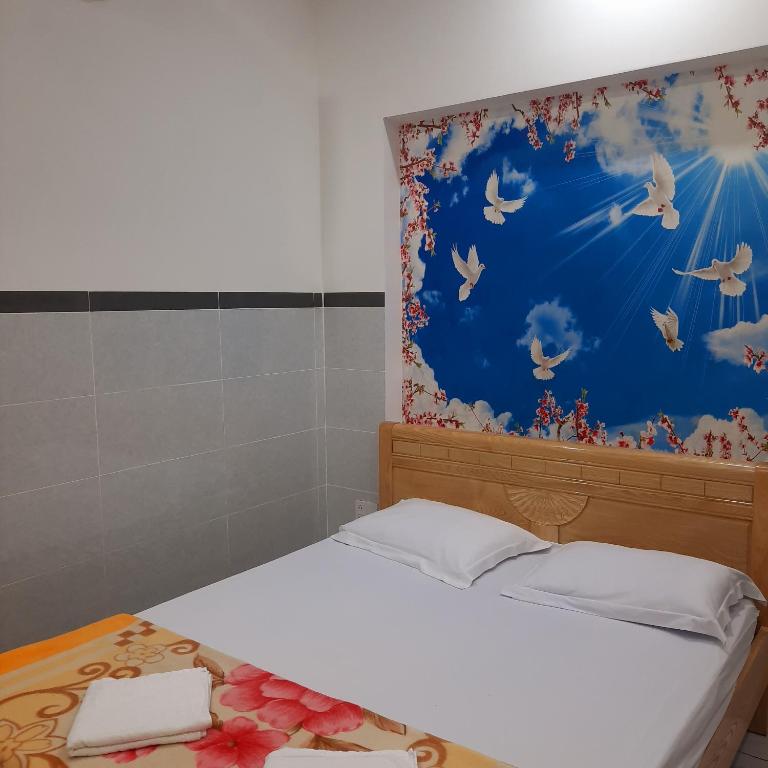 Postel nebo postele na pokoji v ubytování Nhà Nghỉ An Toàn