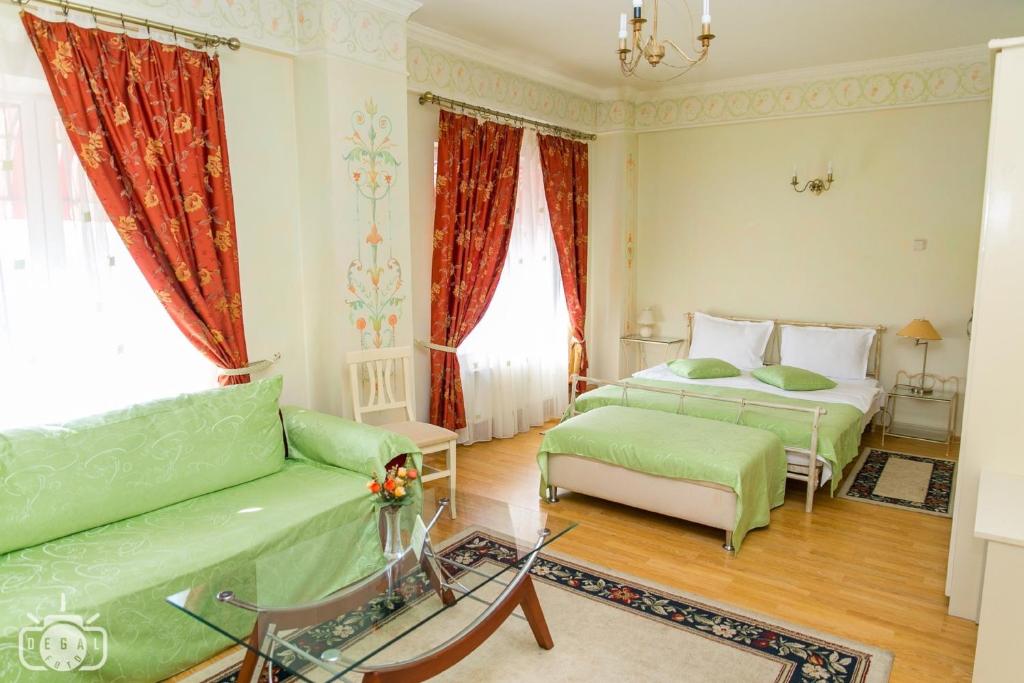 a living room with two beds and a couch at Villa Tamara in Bucharest