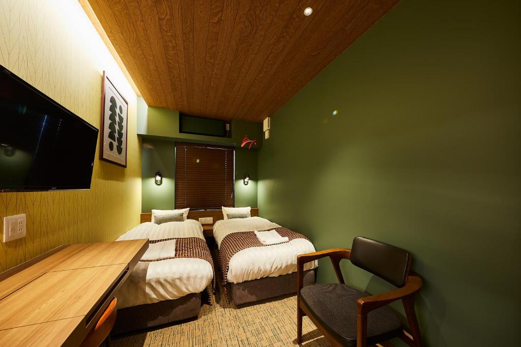 Postel nebo postele na pokoji v ubytování Hotel TORACO konohana