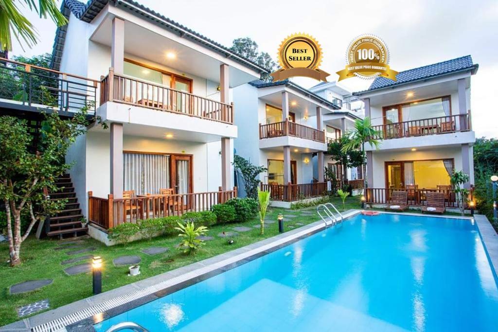 a villa with a swimming pool in front of a house at Mộc Lam Bungalow Phú Quốc in Phú Quốc