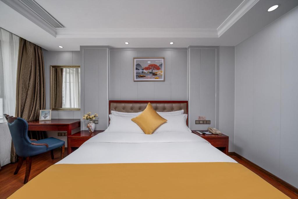 Postel nebo postele na pokoji v ubytování Guangzhou Shi Liu Hotel