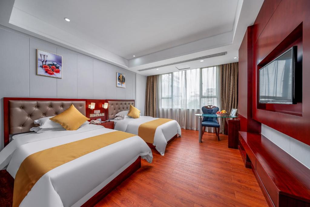 Postel nebo postele na pokoji v ubytování Guangzhou Shi Liu Hotel