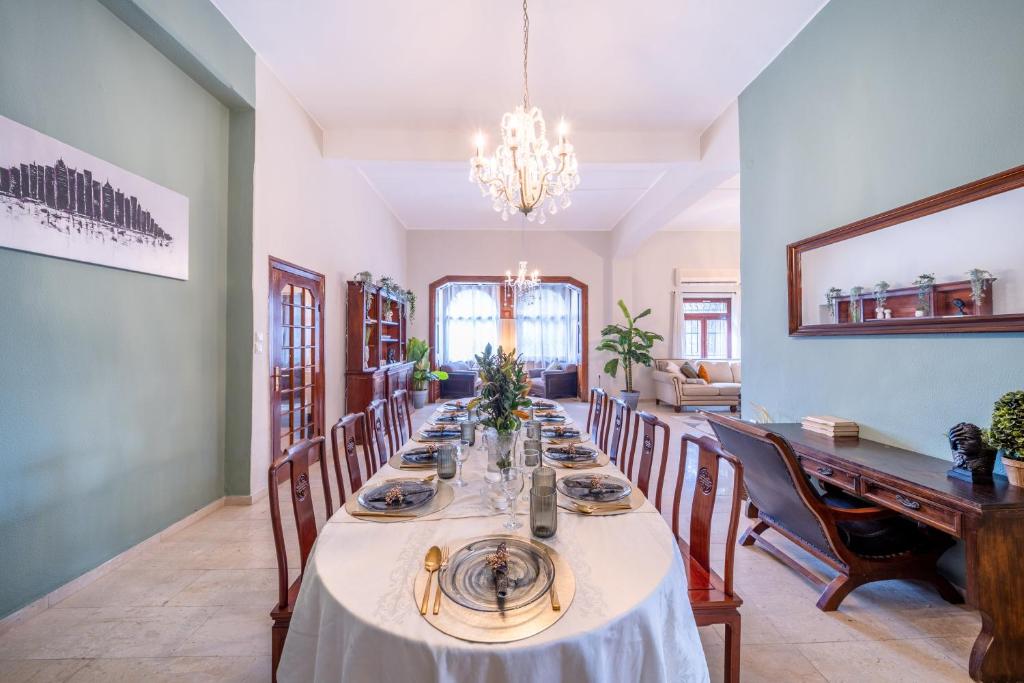 a dining room with a long table and chairs at Art Apartment In Mamila - Villa Rehavia in Jerusalem
