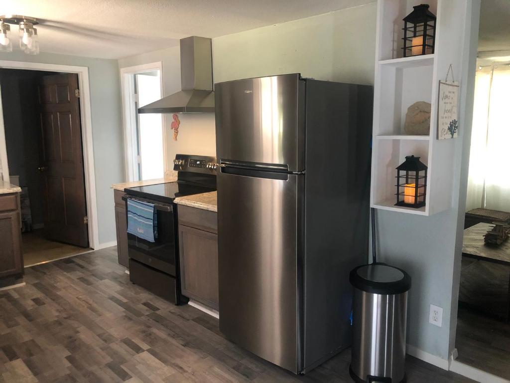a kitchen with a stainless steel refrigerator and a stove at Holiday Hideaway in Rockport