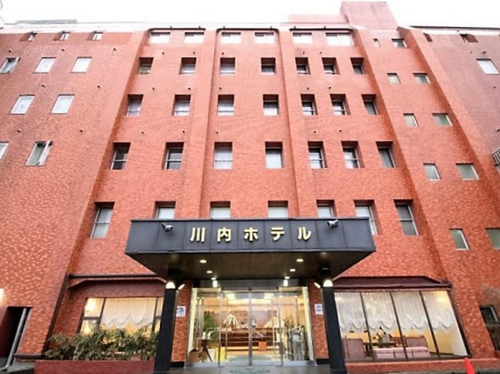 a rendering of the front of a red brick building at 川内ホテル in Satsumasendai
