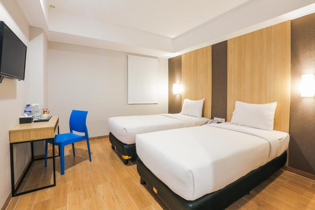 Postel nebo postele na pokoji v ubytování Hotel Citradream Bintaro