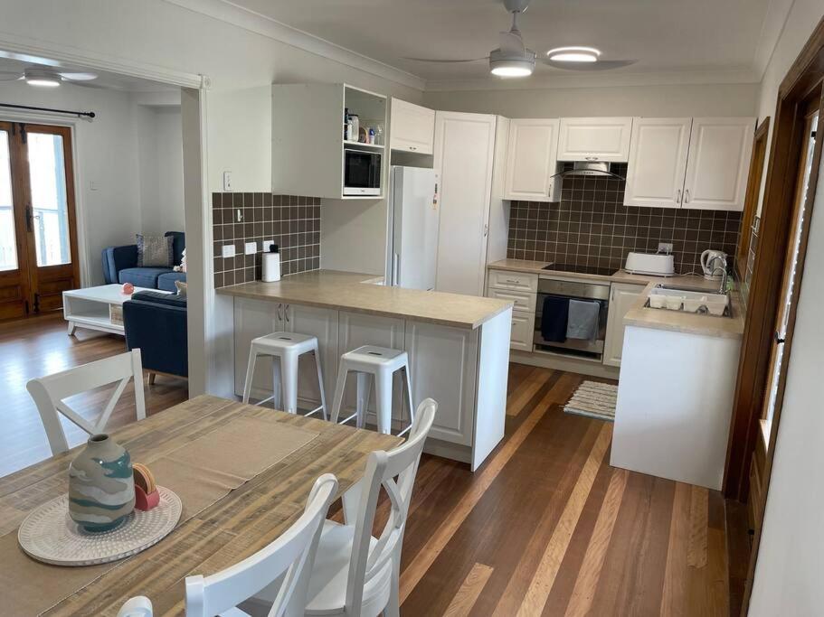 a kitchen and living room with a table and chairs at 13 Cypress Lane in Woorim