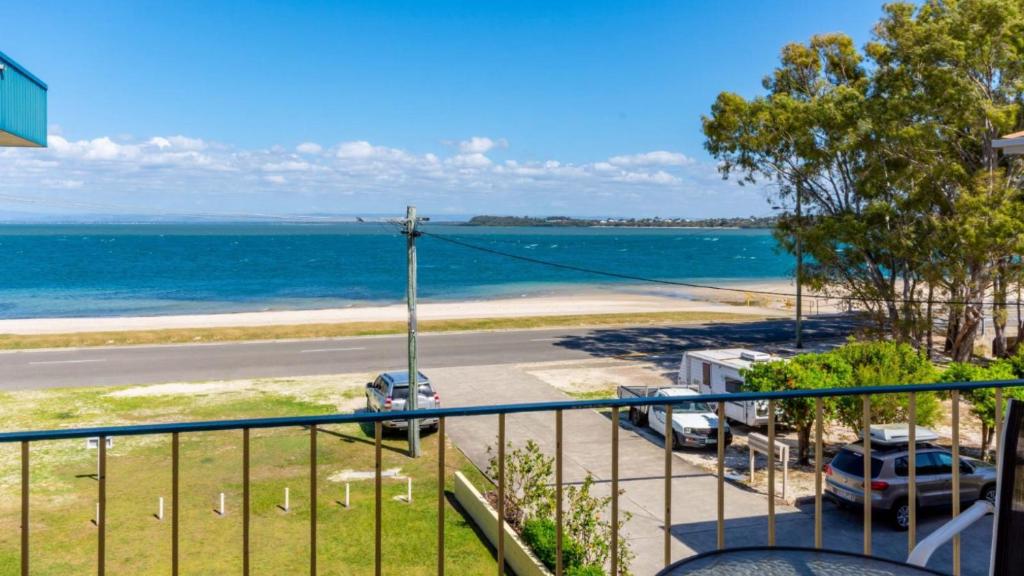 a view of the ocean from a balcony at Fantastic Views from this top floor unit! in Bongaree