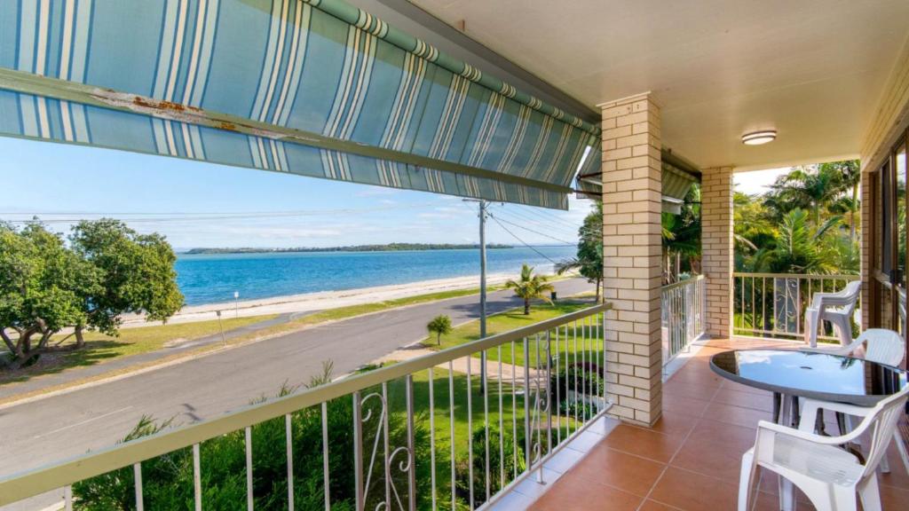 a balcony with a view of the ocean at VIEWS VIEWS VIEWS! Front Top Floor Waterfront Unit - Chnook Apartments South Esp, Bongaree in Bongaree