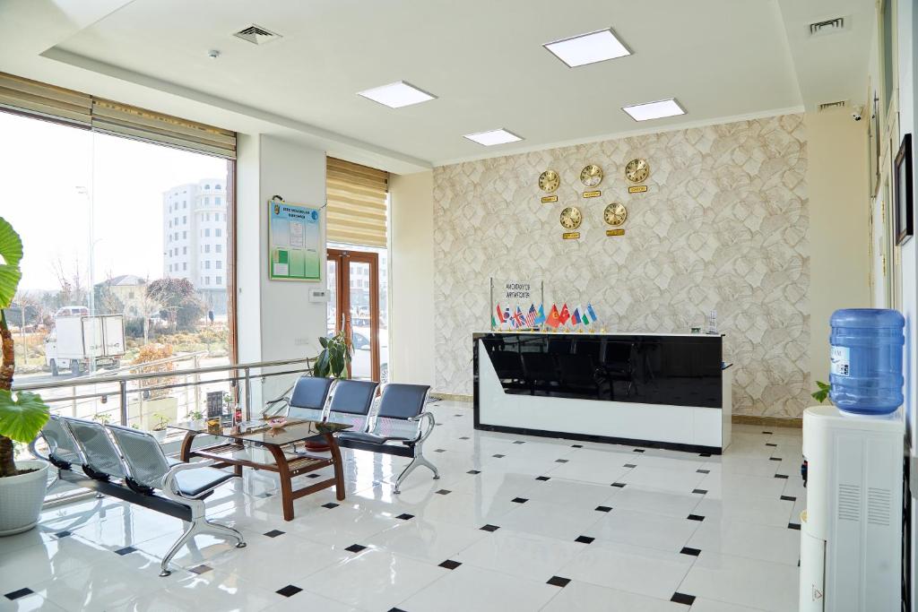 a lobby with a fireplace and chairs in a building at YUKSALISH HOSTEL in Samarkand