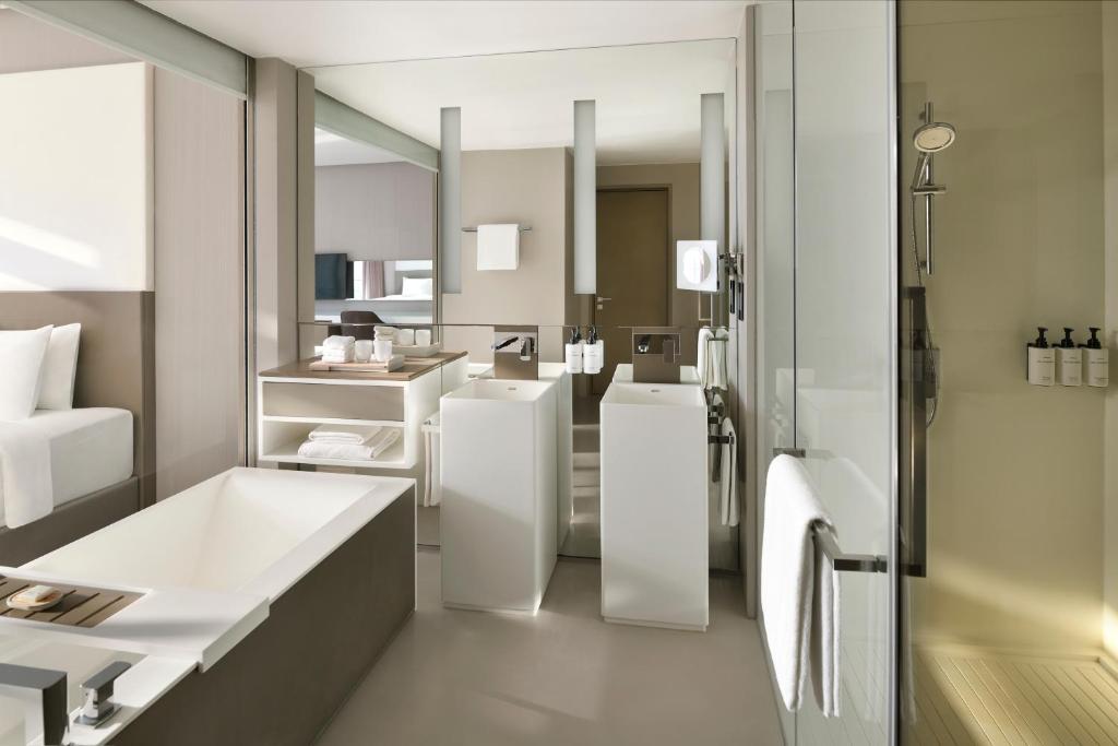 a bathroom with a tub and a sink and a mirror at InterContinental Dubai Marina by IHG in Dubai