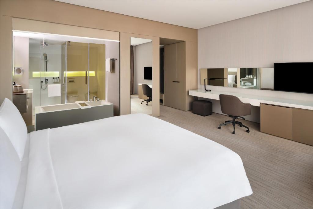 a hotel room with a large bed and a bathroom at InterContinental Dubai Marina by IHG in Dubai