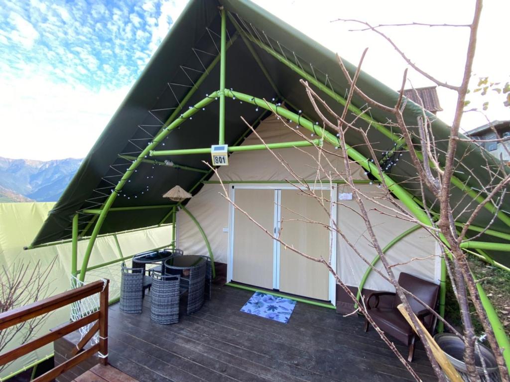 a green and white tent with a wooden deck at 見晴花園山莊Sunshine Villa in Ren&#39;ai
