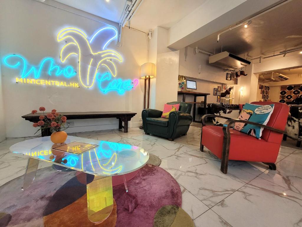 a living room with a neon sign on the wall at Mini Central in Hong Kong