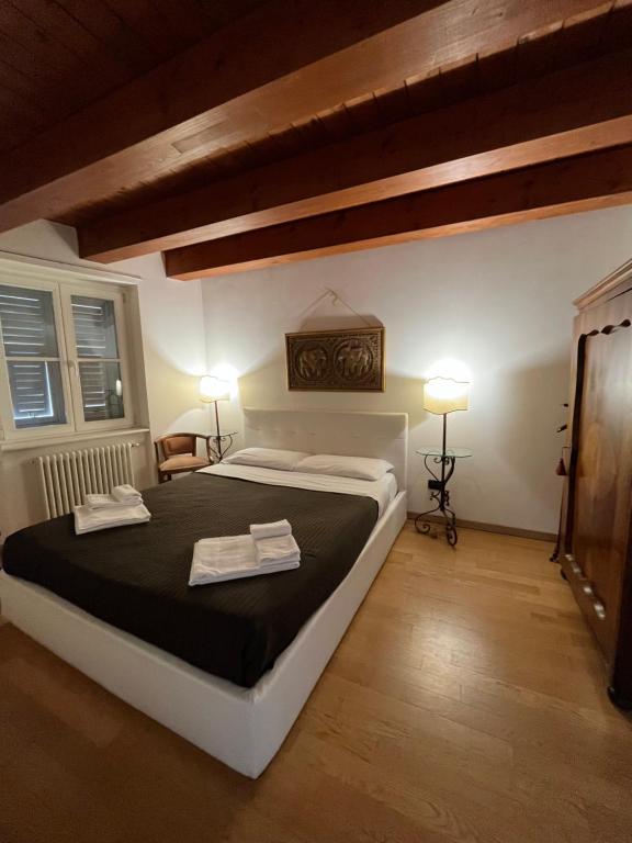 a bedroom with a large bed with two towels on it at Il Borgo in Trieste