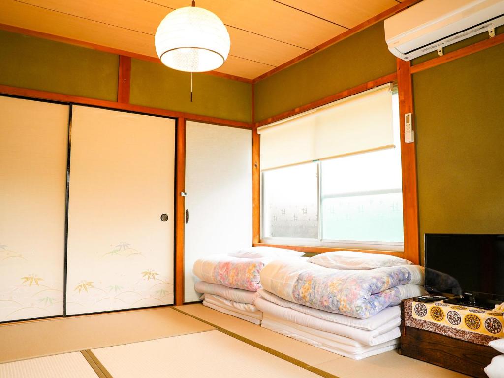 Postel nebo postele na pokoji v ubytování Kokoyui Guest House