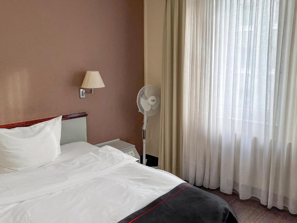 Postel nebo postele na pokoji v ubytování DORMERO Hotel Dessau-Roßlau