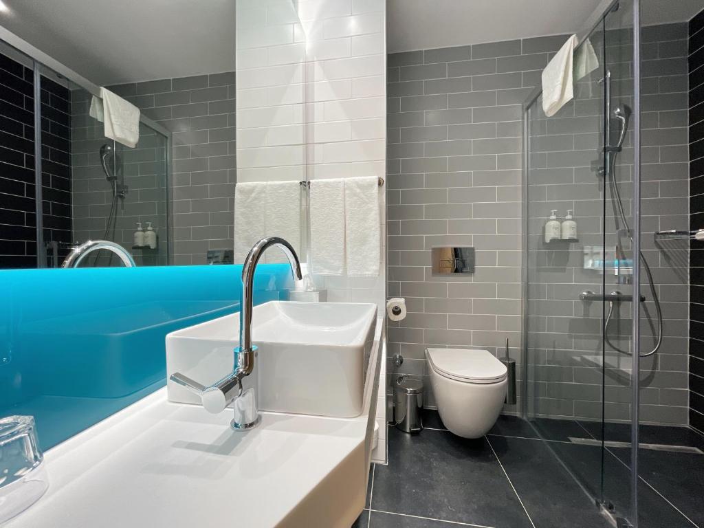 a bathroom with a sink and a toilet at Holiday Inn Express - Ankara - Airport by IHG in Ankara
