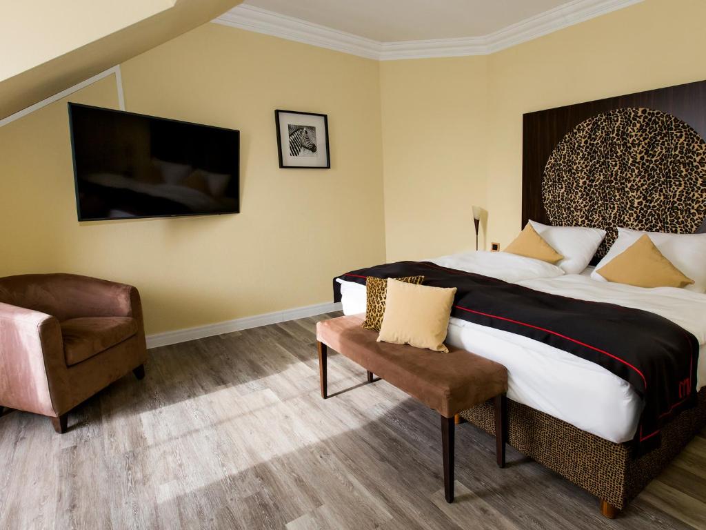 Postel nebo postele na pokoji v ubytování DORMERO Hotel München-Kirchheim Messe