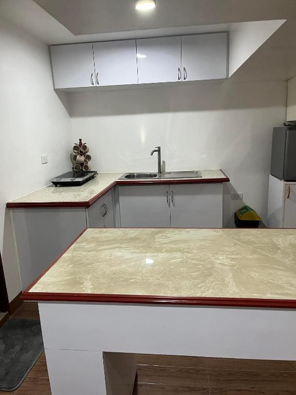 a kitchen with a sink and a counter top at ARJ Property Rental in Paringao La Union in Bauang