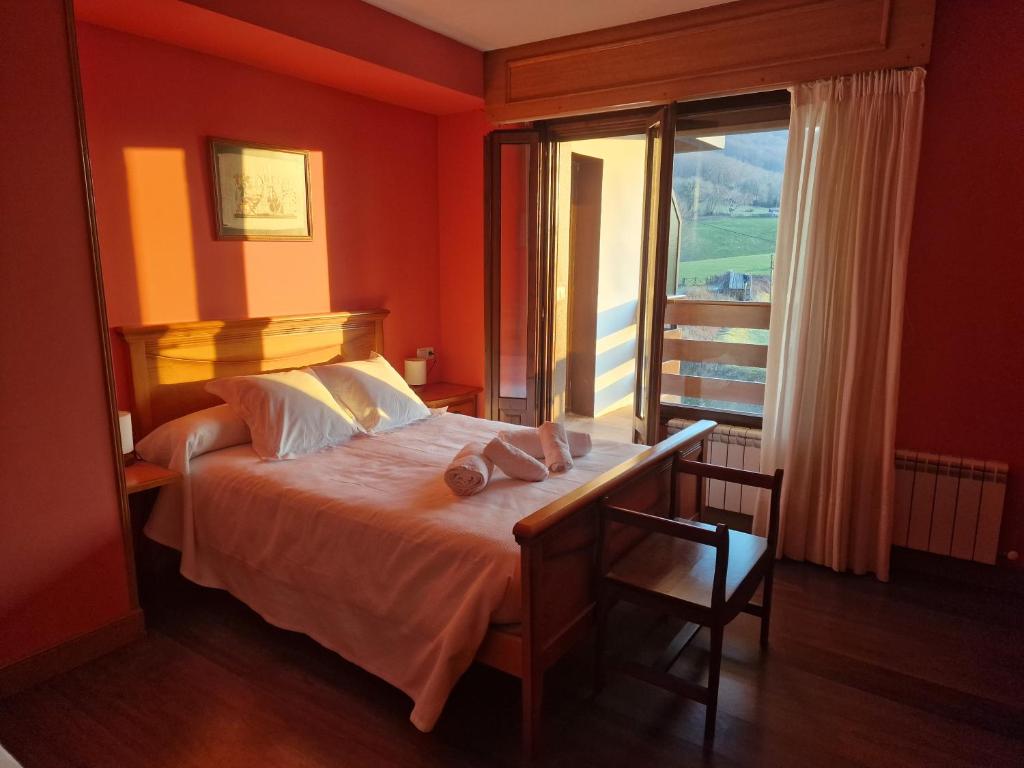 a bedroom with a bed and a large window at Lizuniaga in Bera
