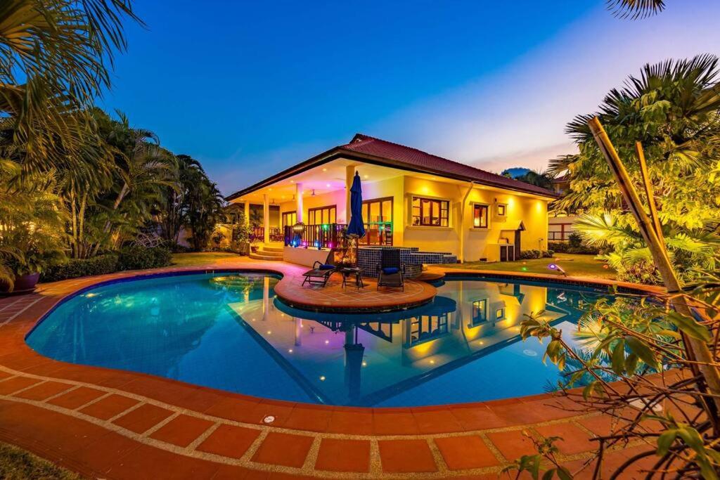 a house with a swimming pool in front of a house at Cozy 3 Bedroom Pool Villa Close to Town - CV3L in Hua Hin
