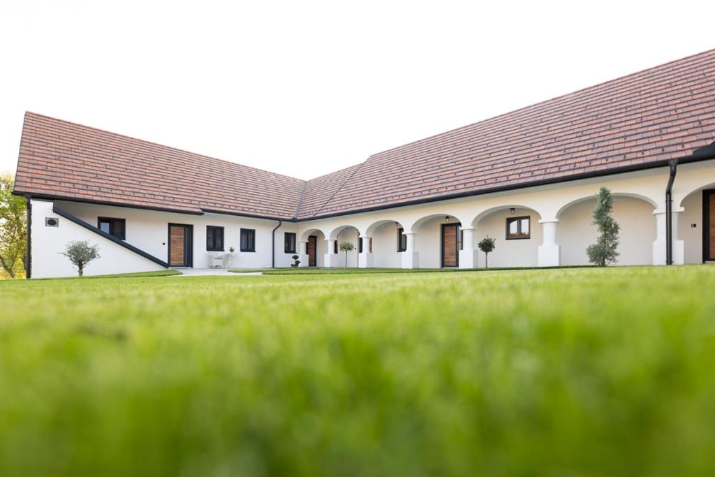 a large white building with a brown roof at Die Arkade in Poppendorf im Burgenland