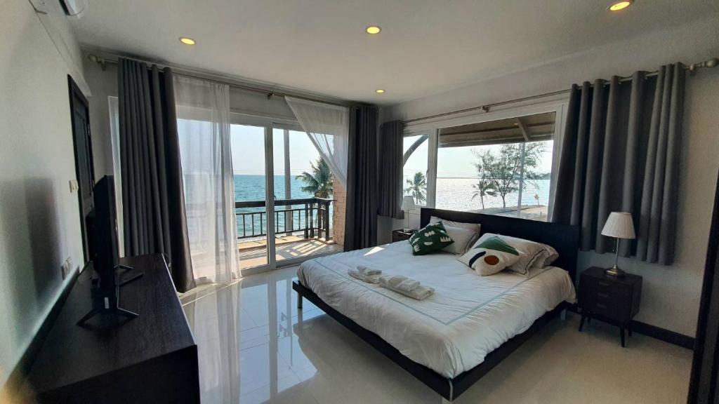 sypialnia z łóżkiem i widokiem na ocean w obiekcie W Sea beach Rayong w mieście Ban Phlong Takhe