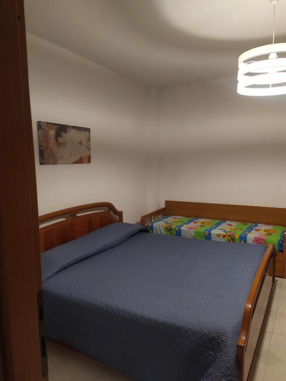 Łóżko lub łóżka w pokoju w obiekcie Casa graziosa con ampio cortile per i tuoi momenti all'aperto
