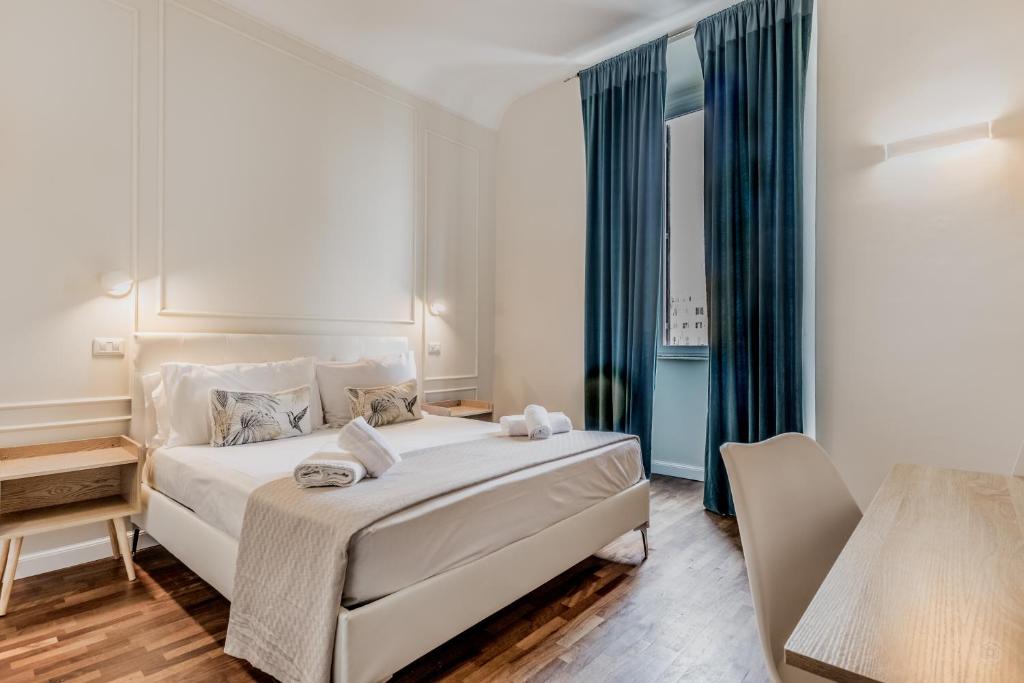 a bedroom with a large bed with blue curtains at Vatican City Guest House in Rome