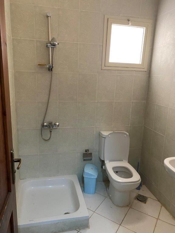 a bathroom with a toilet and a tub and a sink at Makadi Heights, Hurghada in Hurghada