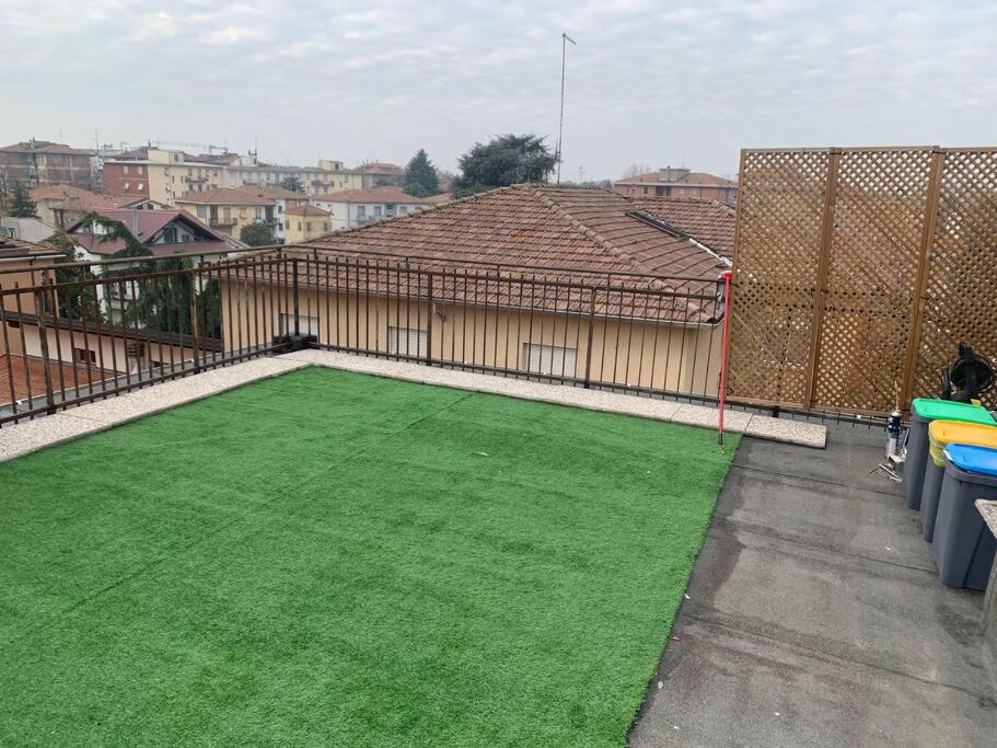 a large yard with green grass in front of a house at Attico con terrazzo. in Parma