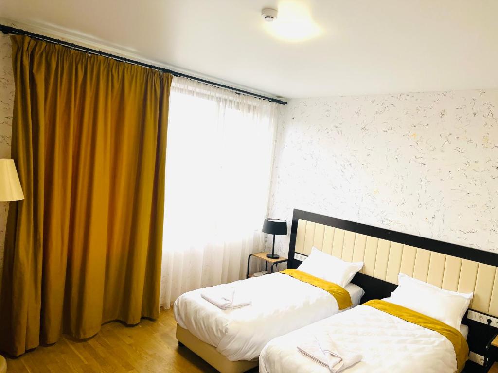 Postel nebo postele na pokoji v ubytování Green Hotel ANG