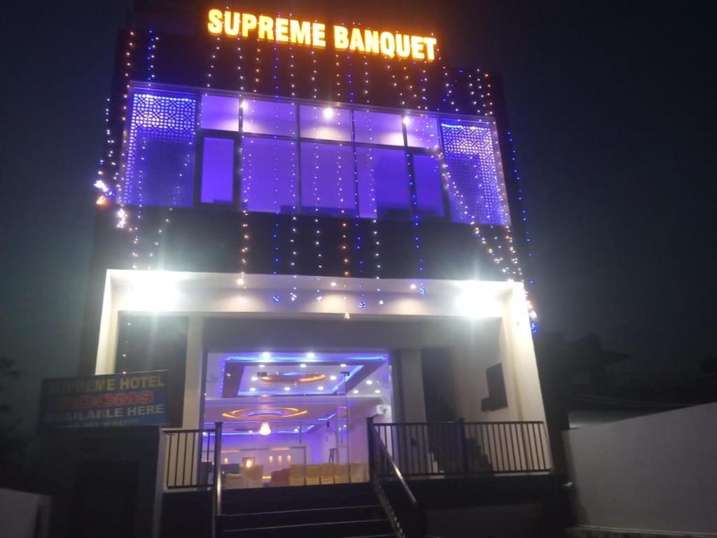 a building with blue lights on top of it at Hotel Supreme & Banquet in Sirhind