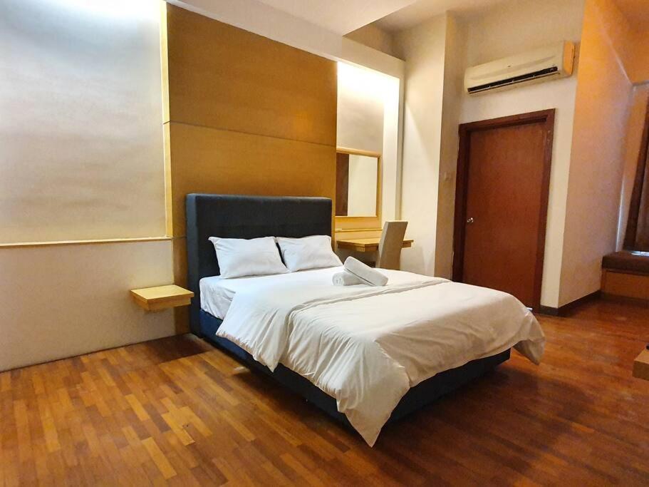 a bedroom with a large bed with white sheets at [HERITAGE 3] HOMESTAY Studio 4Pax, FREE WIFI NETFLIX in Seri Kembangan