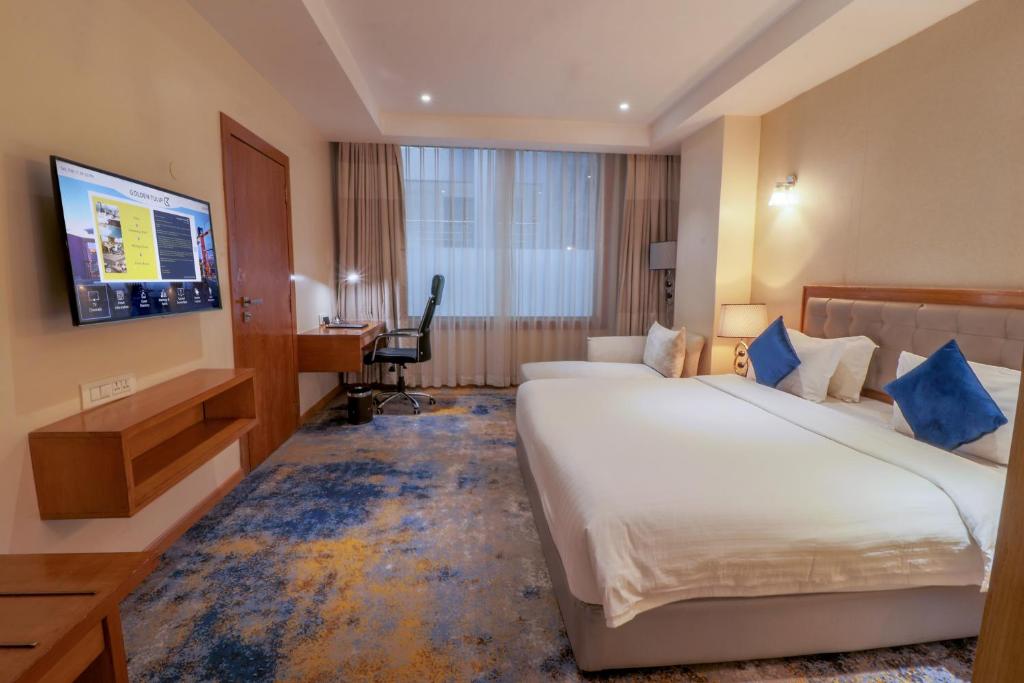 Postel nebo postele na pokoji v ubytování Golden Tulip Westlands Nairobi