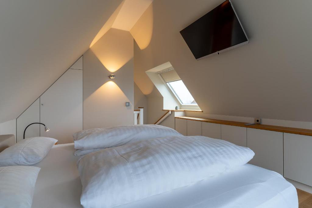 Postel nebo postele na pokoji v ubytování Ferienhaus Kirchenstraße Appartement Achtern Diek OG