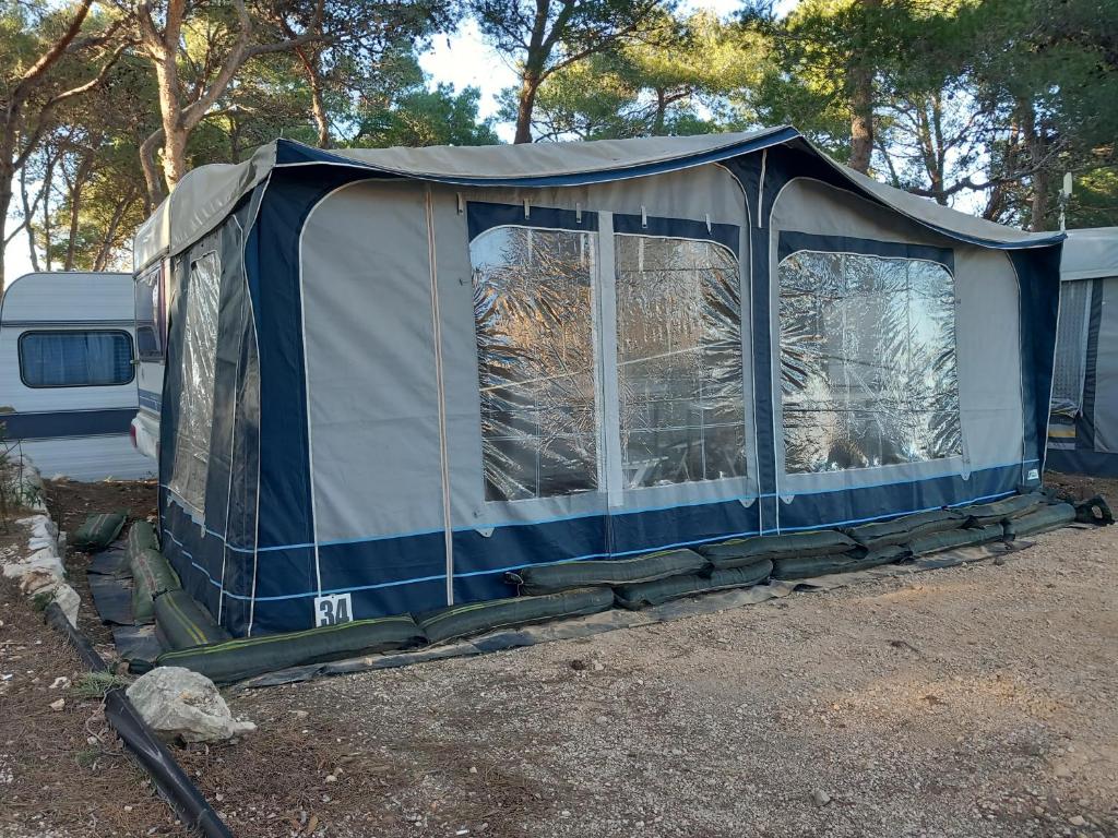 a tent is set up in a parking lot at Caravan near the sea 6 in Ugljan