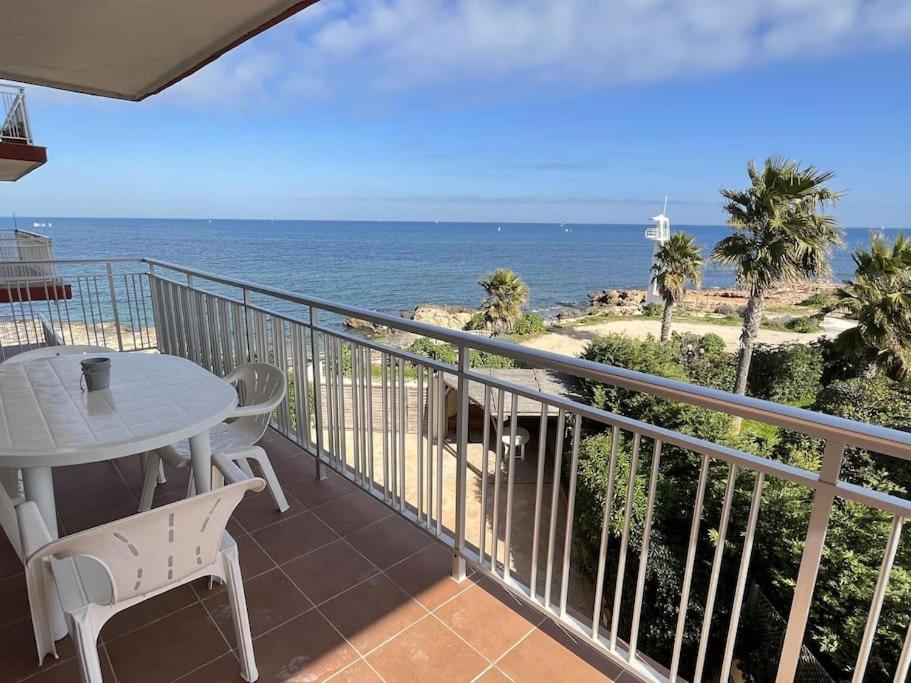 a balcony with a table and a view of the ocean at El Trampolí By El Conserje in Denia