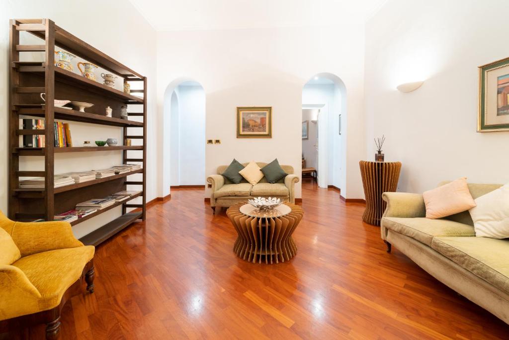 a living room with two couches and a table at Zamboni Suite in Bologna
