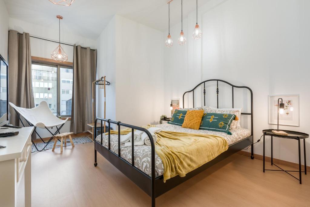 una camera con letto e scrivania di Oporto Bonjardim Residence a Porto